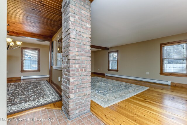 entrance foyer featuring wooden ceiling, a baseboard radiator, hardwood / wood-style flooring, and a chandelier