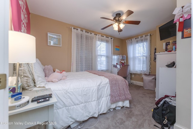 bedroom with ceiling fan and light colored carpet