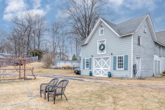 rear view of property featuring a yard