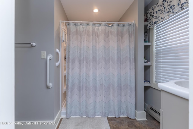 bathroom with baseboard heating and curtained shower