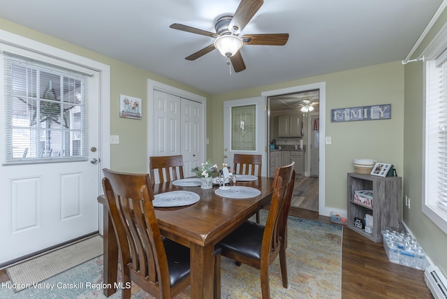 dining area with ceiling fan, dark hardwood / wood-style flooring, plenty of natural light, and a baseboard radiator