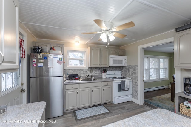 kitchen with sink, plenty of natural light, and white appliances