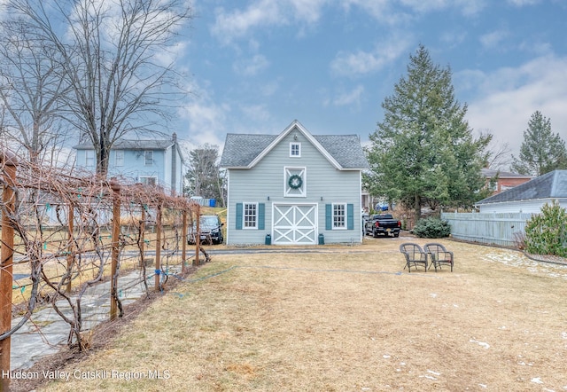 rear view of house with a yard