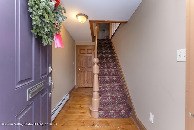 entryway with a baseboard radiator and light hardwood / wood-style flooring