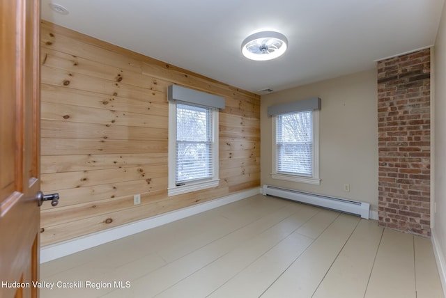 empty room with a baseboard radiator and wooden walls