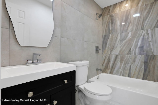 full bath featuring shower / bathtub combination, tile walls, toilet, and vanity