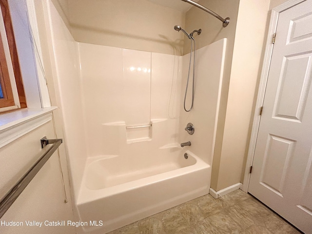 bathroom with shower / washtub combination