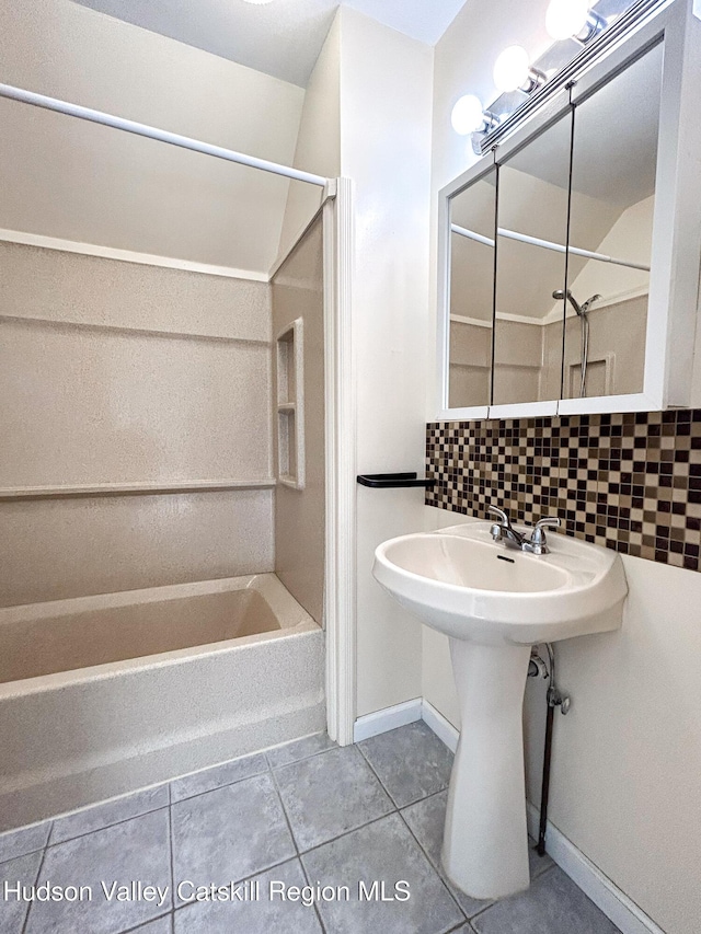 bathroom featuring tile patterned flooring, decorative backsplash, and shower / tub combination