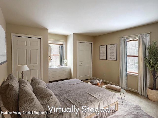 carpeted bedroom featuring multiple windows