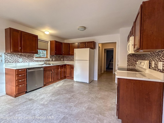 kitchen with decorative backsplash, sink, and white appliances