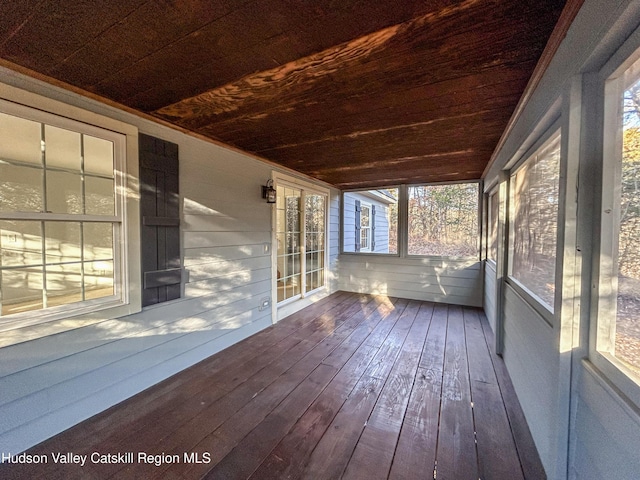 unfurnished sunroom featuring a wealth of natural light and wood ceiling