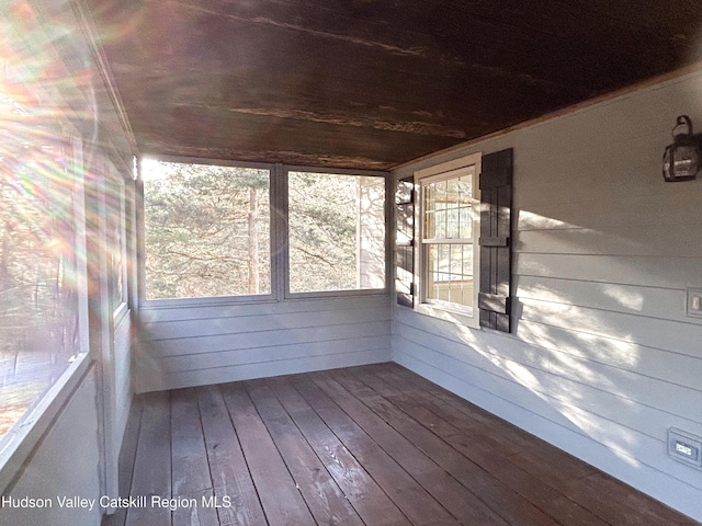 unfurnished sunroom with wood ceiling