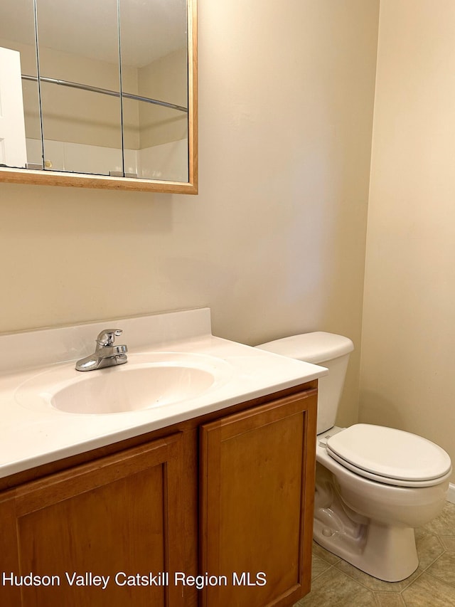 bathroom with tile patterned floors, vanity, and toilet