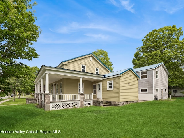 125 Water St, Franklin, NY 13775 - view of front of house featuring covered porch, a front yard, and metal roof