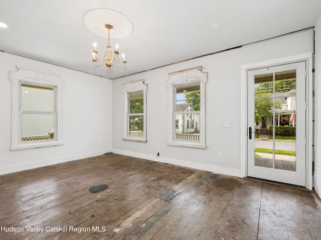 125 Water St, Franklin, NY 13775 - unfurnished dining area featuring a chandelier, baseboards, and hardwood / wood-style floors