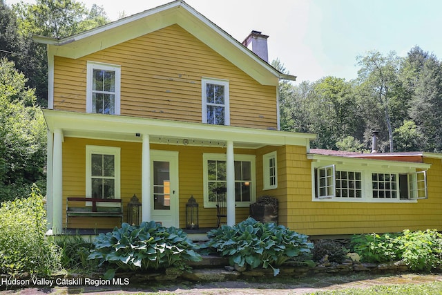 10 Erickson Rd, Hardenburgh, NY 12406 - view of front of property featuring covered porch and a chimney