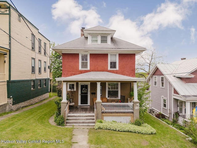 15 Mckinstry Pl, Hudson, NY 12534 - traditional style home with a chimney, covered porch, and a front yard