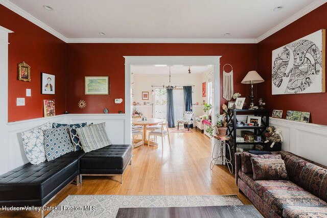 15 Mckinstry Pl, Hudson, NY 12534 - living room with wood finished floors, crown molding, wainscoting, a decorative wall, and a chandelier