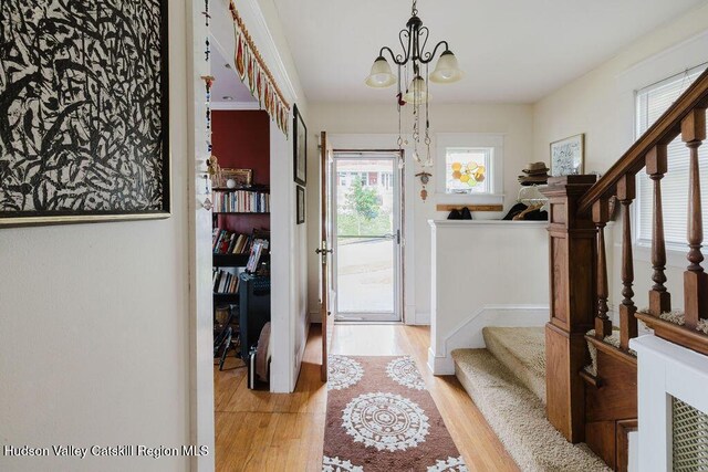 15 Mckinstry Pl, Hudson, NY 12534 - entrance foyer featuring light wood-type flooring, stairway, and a chandelier