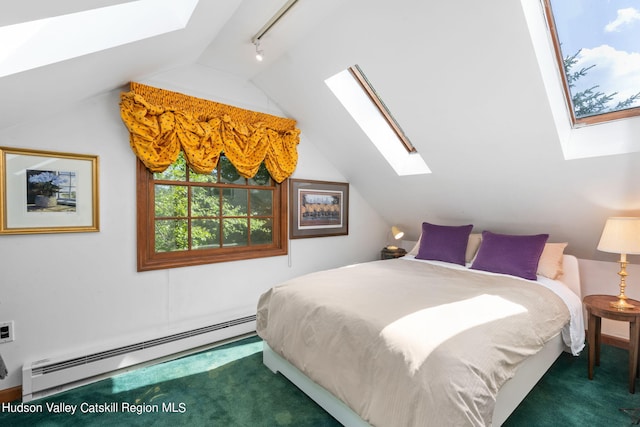 bedroom featuring lofted ceiling with skylight, dark carpet, and a baseboard heating unit