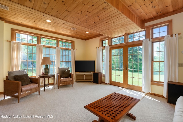 sitting room featuring french doors, carpet floors, and wooden ceiling