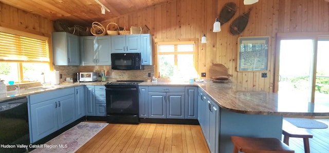 490 Mill St, Windham, NY 12496 - kitchen featuring black appliances, a peninsula, vaulted ceiling, wood ceiling, and blue cabinetry