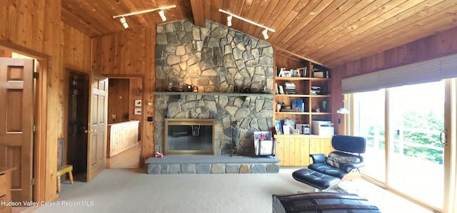 490 Mill St, Windham, NY 12496 - carpeted living room with lofted ceiling, a fireplace, wooden ceiling, and wooden walls