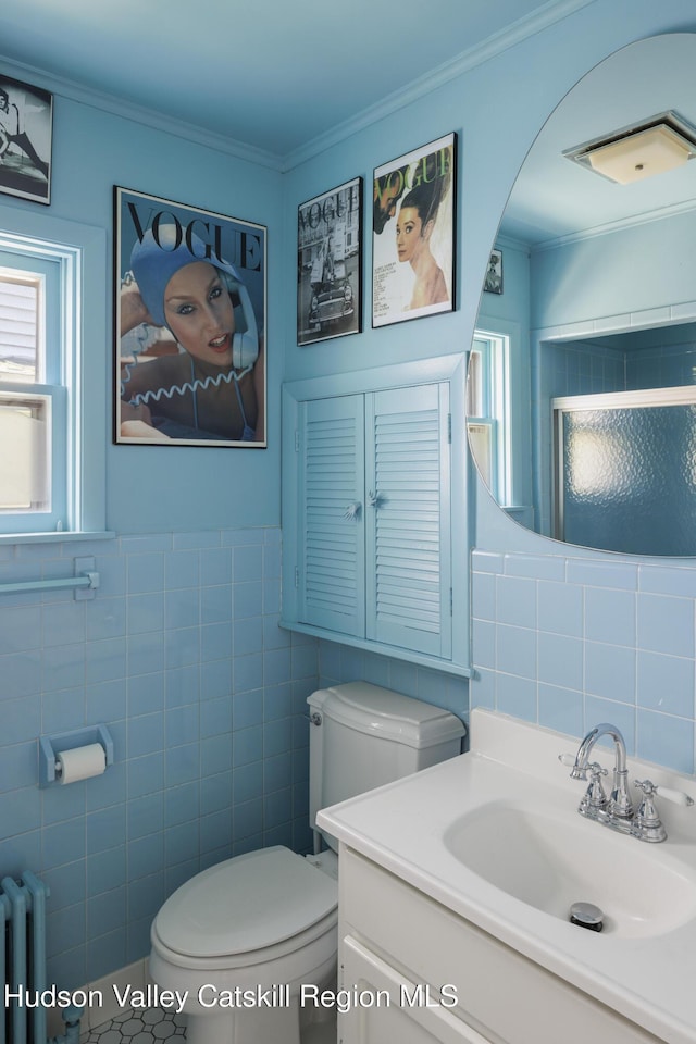 131 William St, Catskill, NY 12414 - full bathroom with tile walls, toilet, radiator, vanity, and healthy amount of natural light