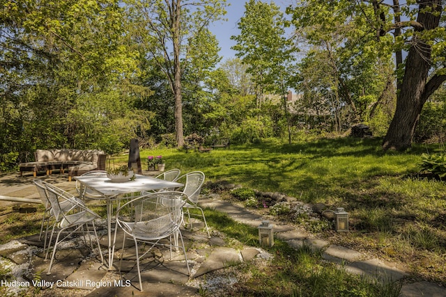 131 William St, Catskill, NY 12414 - view of yard featuring outdoor dining space, a patio area, and view of wooded area
