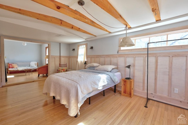 825 Union St, Hudson, NY 12534 - bedroom featuring wainscoting, beamed ceiling, and hardwood / wood-style flooring