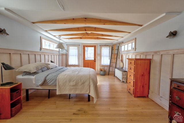 825 Union St, Hudson, NY 12534 - bedroom with radiator heating unit, wainscoting, light wood-type flooring, and a decorative wall