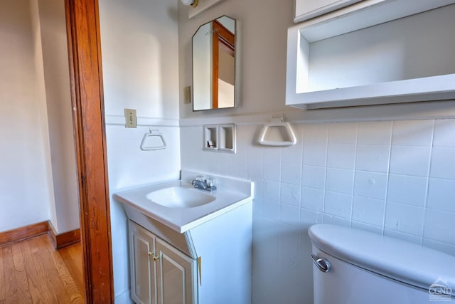 825 Union St, Hudson, NY 12534 - half bath featuring tile walls, vanity, toilet, and a wainscoted wall