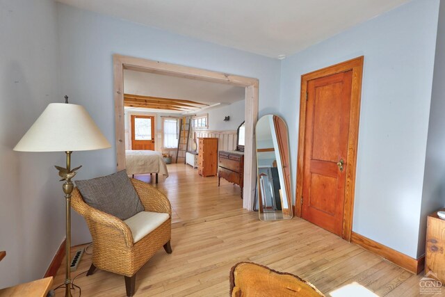 825 Union St, Hudson, NY 12534 - living area with light wood finished floors, baseboards, and beamed ceiling