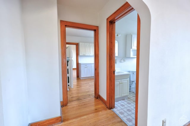 825 Union St, Hudson, NY 12534 - hallway with arched walkways, light wood-style floors, and baseboards