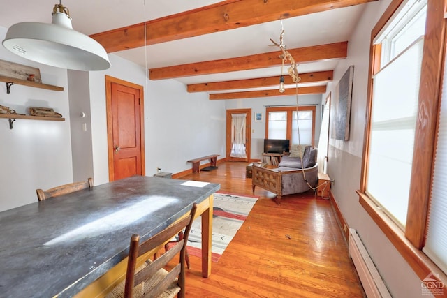 825 Union St, Hudson, NY 12534 - dining space with a baseboard heating unit, light wood finished floors, baseboards, and beam ceiling
