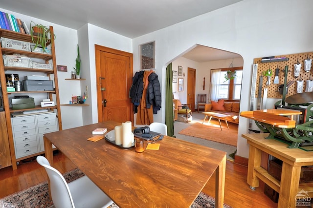 825 Union St, Hudson, NY 12534 - dining area with arched walkways and wood-type flooring