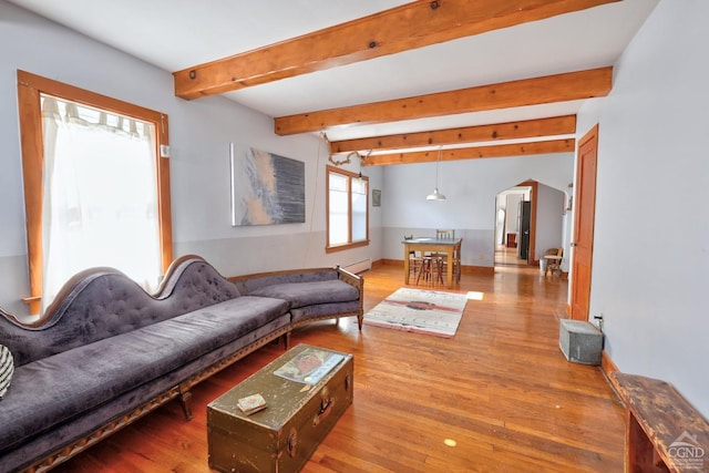 825 Union St, Hudson, NY 12534 - living area featuring wood finished floors, a baseboard radiator, beam ceiling, and baseboards