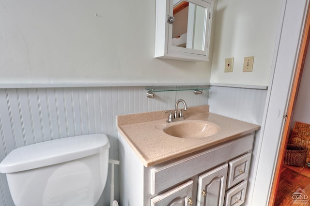 825 Union St, Hudson, NY 12534 - half bath featuring wainscoting, vanity, and wood finished floors