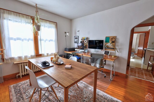 825 Union St, Hudson, NY 12534 - dining area featuring wood finished floors, arched walkways, and baseboards