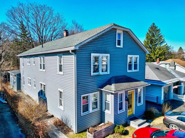 825 Union St, Hudson, NY 12534 - view of front of home featuring a shingled roof and a chimney