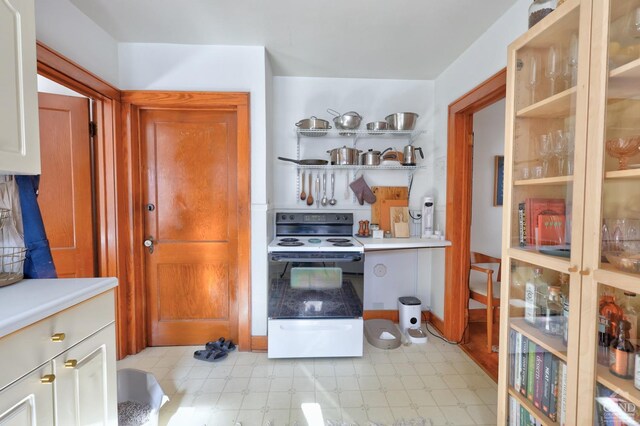 825 Union St, Hudson, NY 12534 - kitchen featuring electric stove, light countertops, light floors, and open shelves