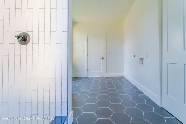 bathroom featuring tiled shower, tile patterned floors, and baseboards