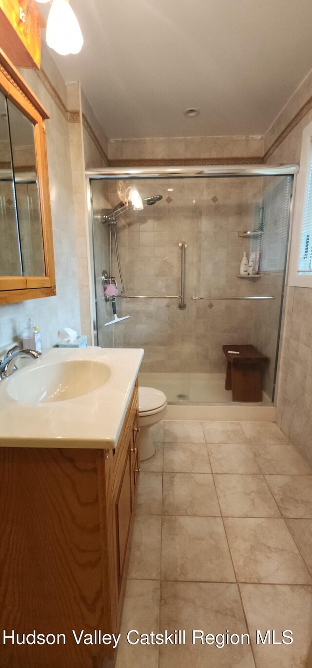 56 Highlands Dr Unit F3, Hunter, NY 12442 - full bathroom with vanity, a shower stall, and tile patterned floors