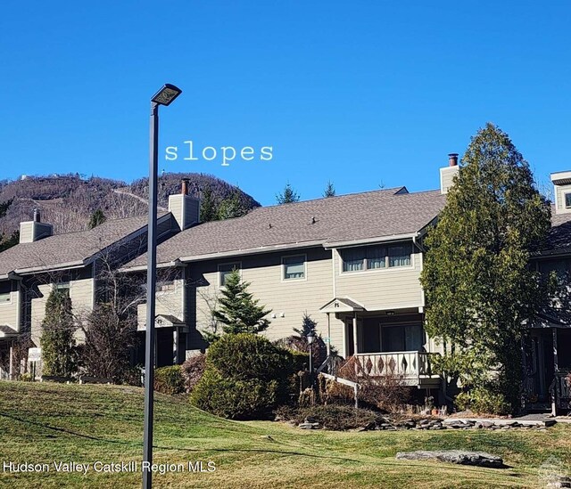 56 Highlands Dr Unit F3, Hunter, NY 12442 - rear view of property with a chimney and a yard