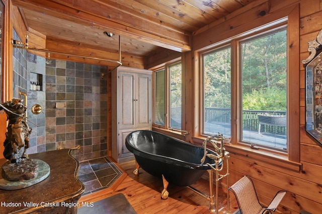 bathroom featuring wood ceiling, wood walls, a washtub, and wood-type flooring