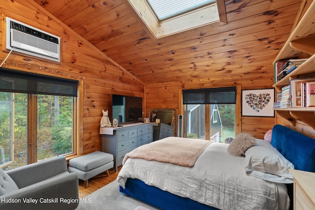 bedroom featuring lofted ceiling with skylight, wooden walls, light hardwood / wood-style flooring, a wall mounted AC, and wood ceiling