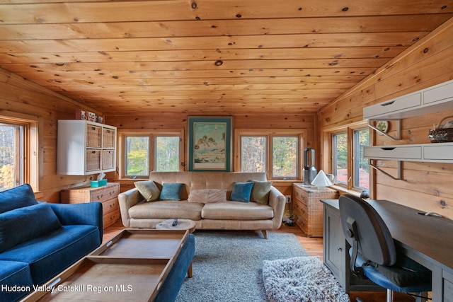 living room with lofted ceiling, wooden walls, light hardwood / wood-style flooring, and wooden ceiling