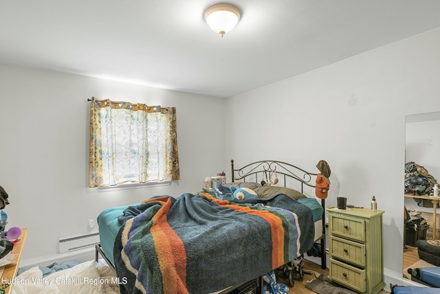 bedroom with baseboard heating and baseboards