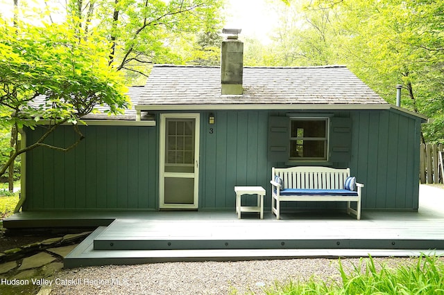 3 Dymond Rd, Kerhonkson, NY 12446 - rear view of house with a chimney, a deck, a shingled roof, and an outbuilding
