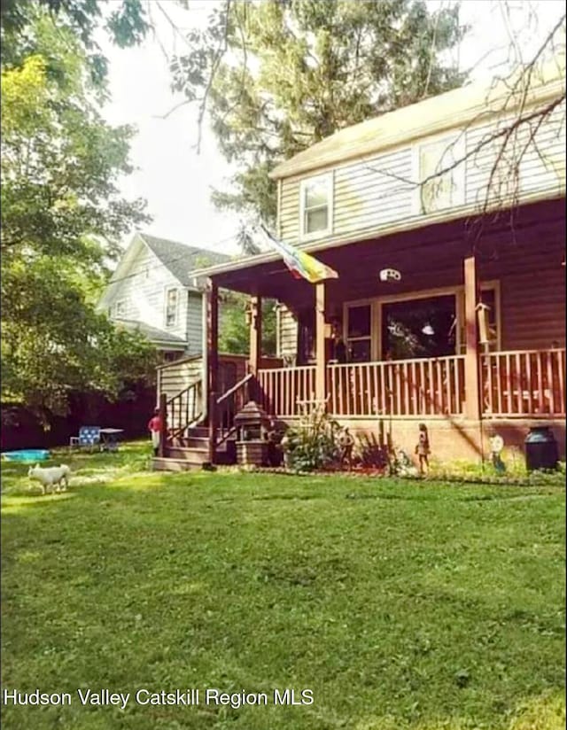 4 Tanners Ln, Hudson, NY 12534 - back of house with covered porch and a lawn